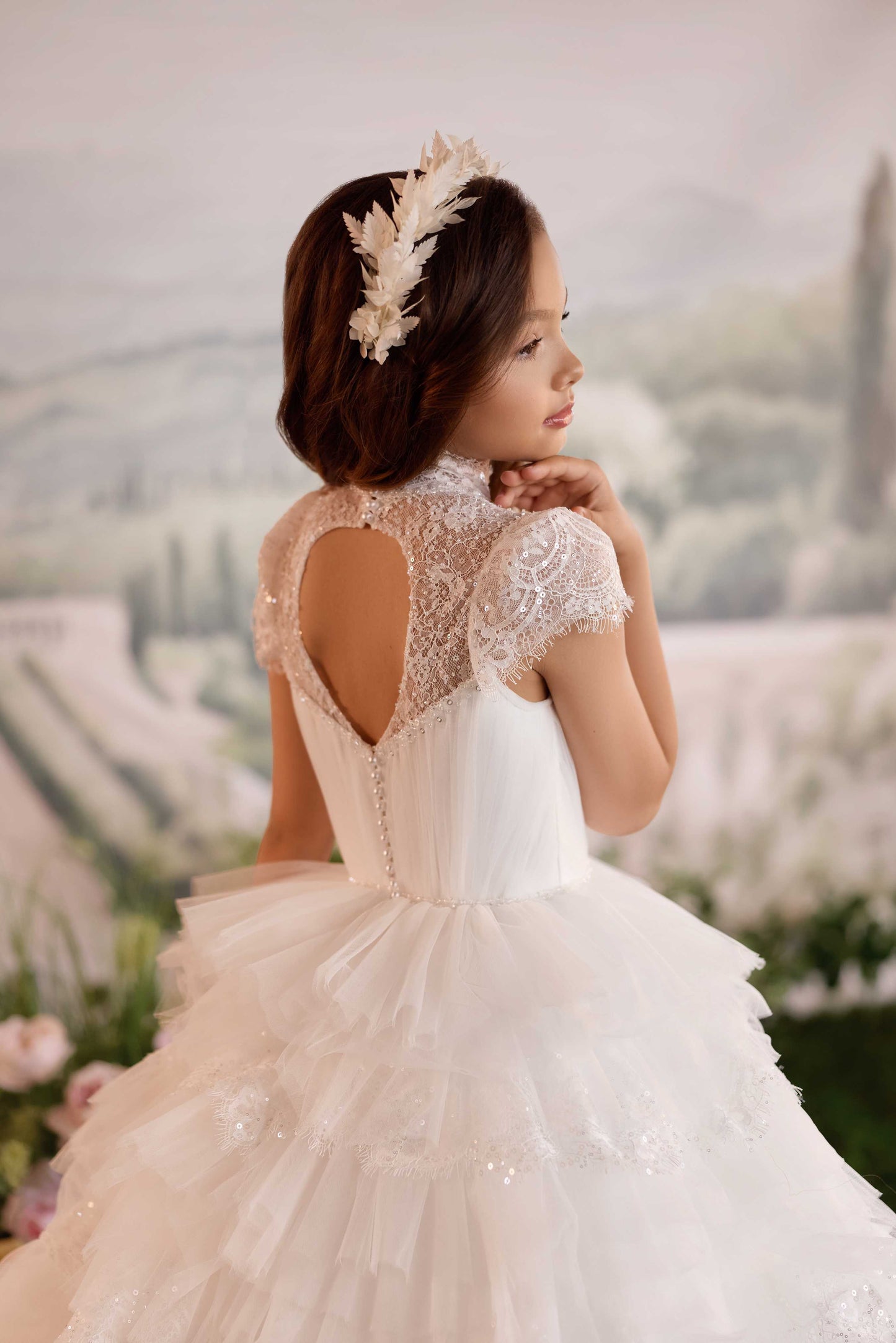 Detailed close-up of an elegant illusion high neckline featuring intricate beaded embroidery and sheer lace cap sleeves.