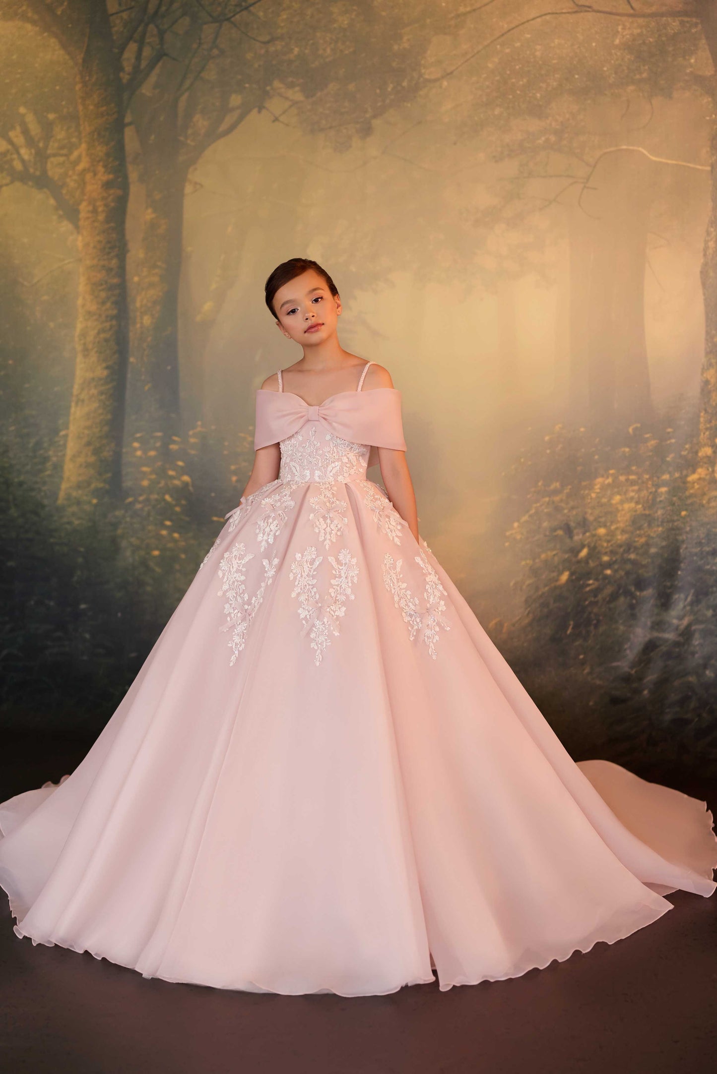 Back view of a premium pink flower girl dress featuring a dramatic sweeping floor-length ball gown train.