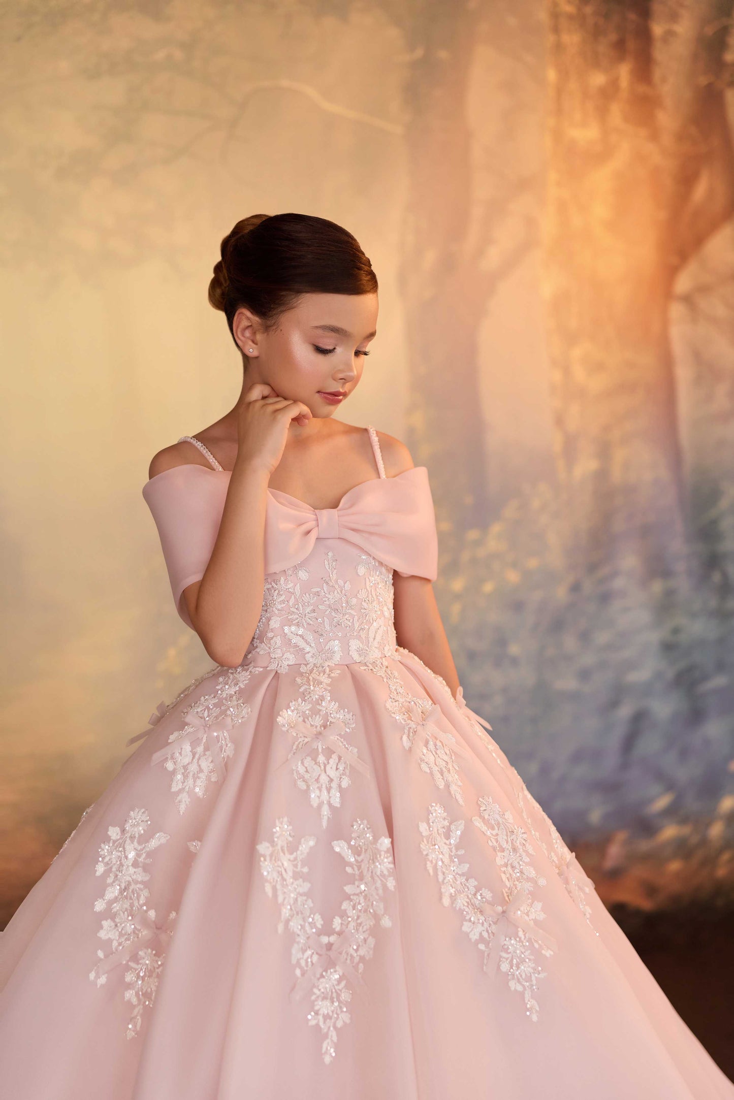 Detailed close-up of intricate white floral lace embroidery cascading down a blush pink tulle and chiffon princess gown.