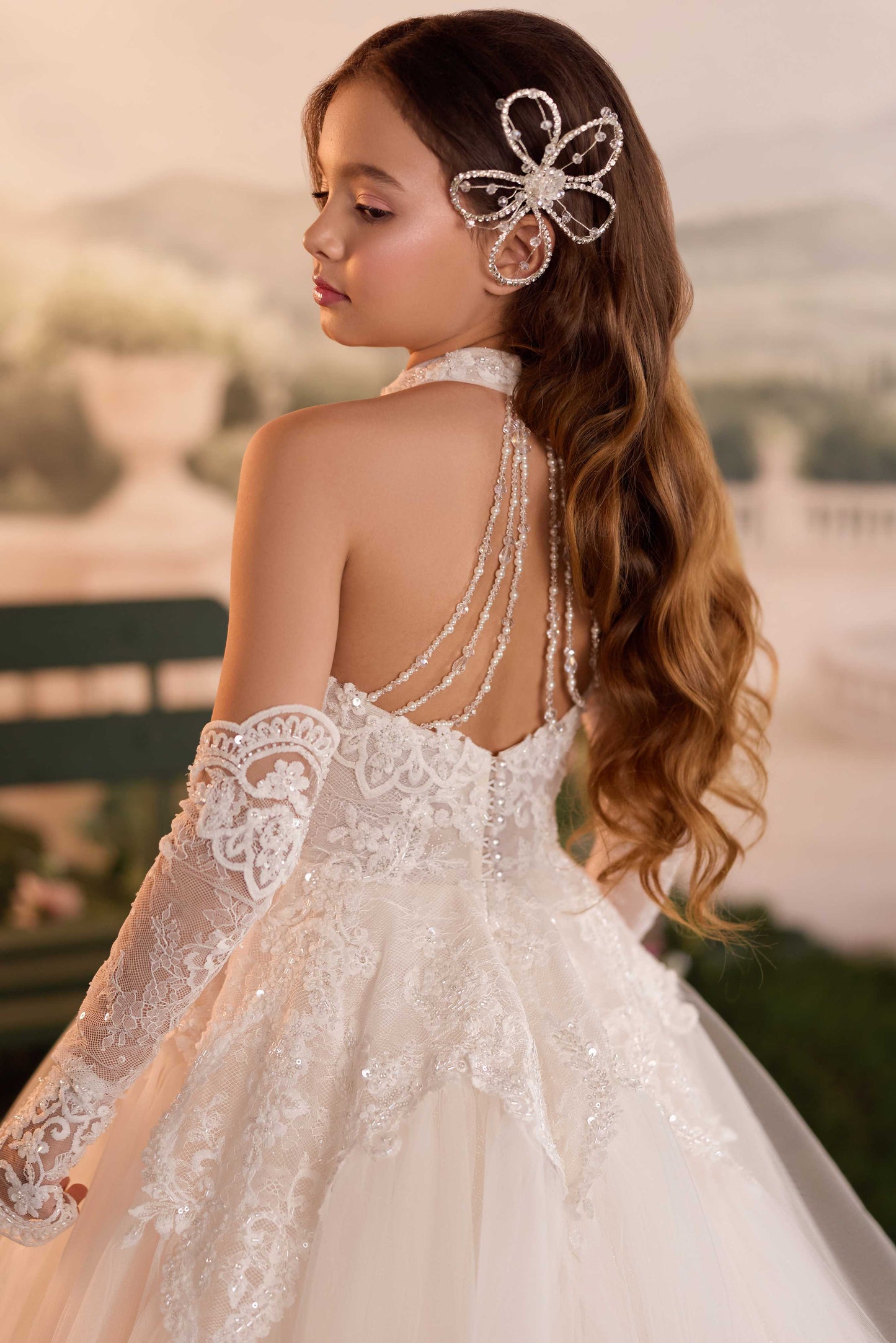 Close-up shot of the high halter neckline and intricate floral lace applique on the bodice of the Genevieve ballgown.