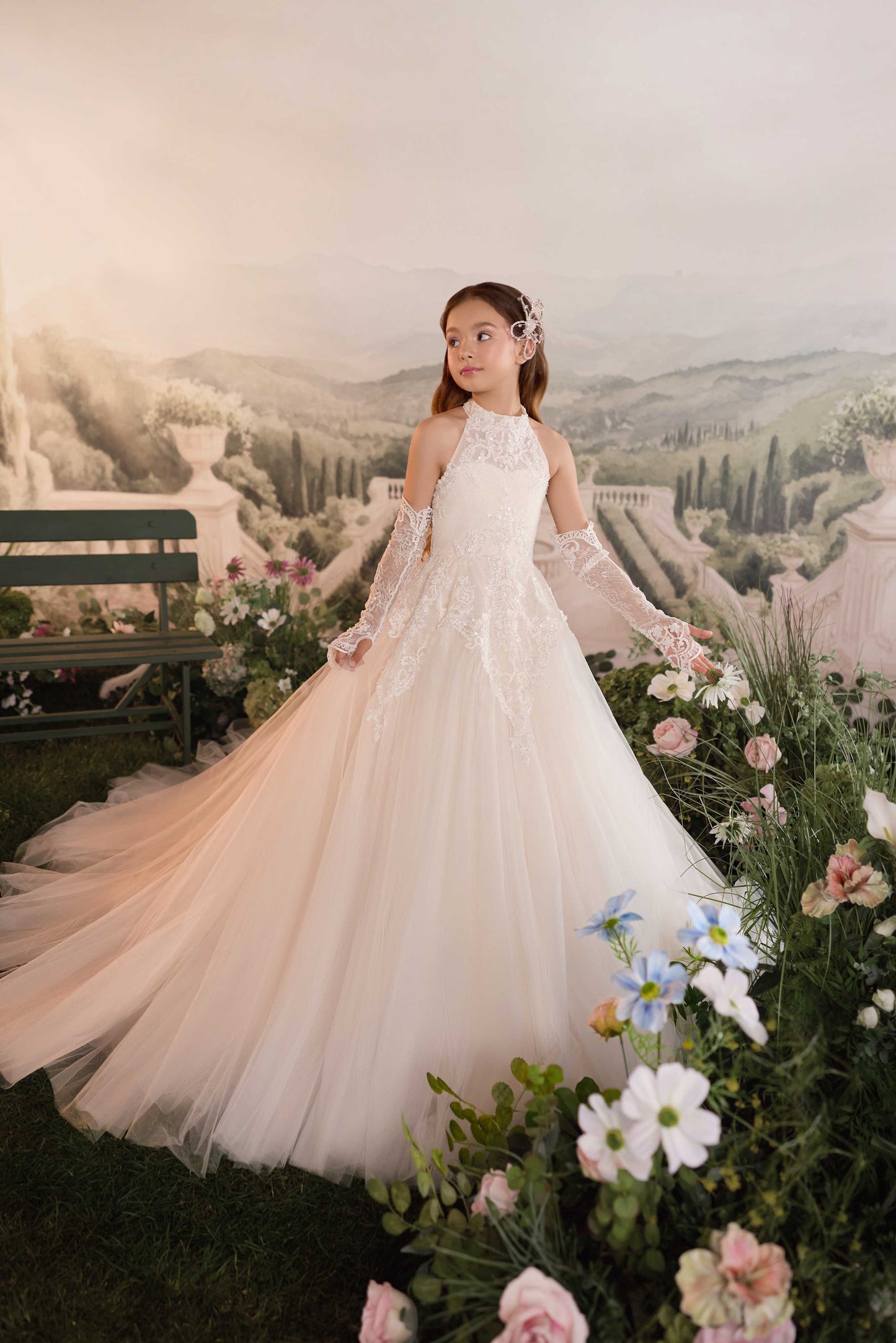 etailed close-up of the shimmering draped beaded strands on the open back of the Genevieve luxury flower girl gown.