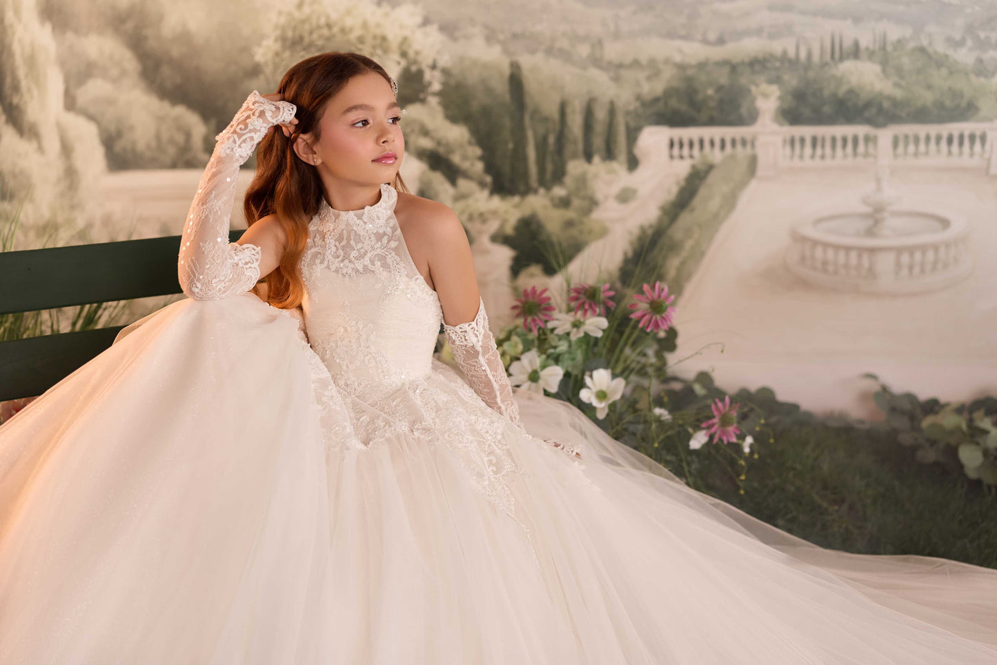 A wide photo highlighting the dramatic, long sweeping multi-layered tulle train of the Genevieve formal dress.