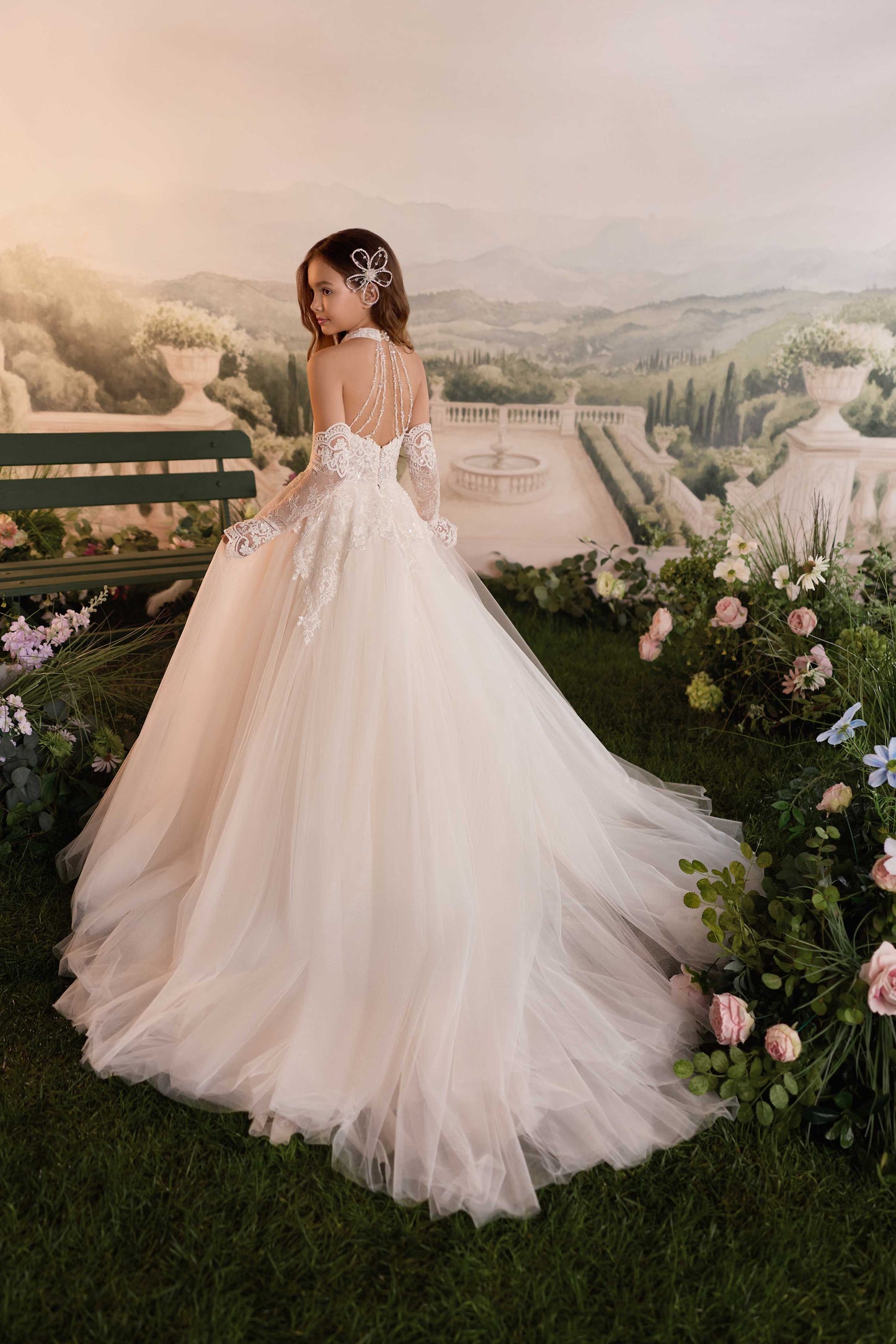 Back view of a young girl walking to show the profile, fullness, and volume of the Genevieve tulle pageant ballgown.