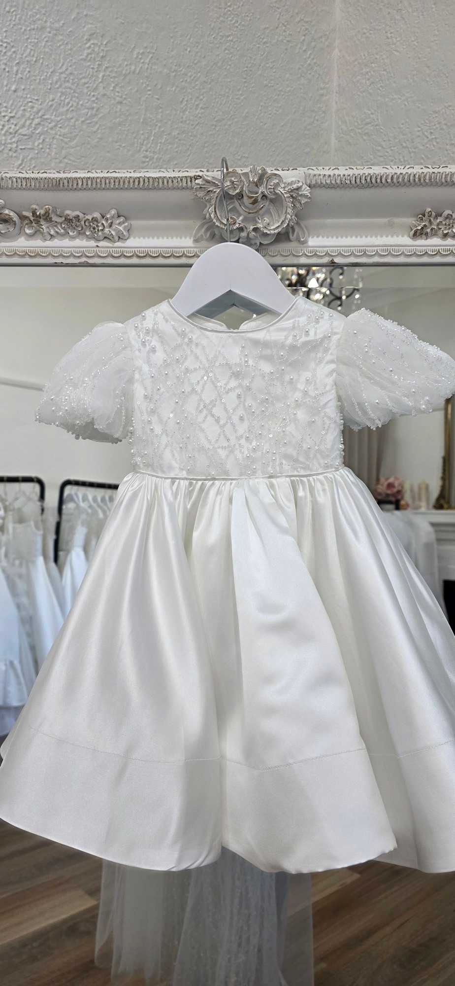 Close-up of pearl lace and embroidery on the Catina Christening Gown