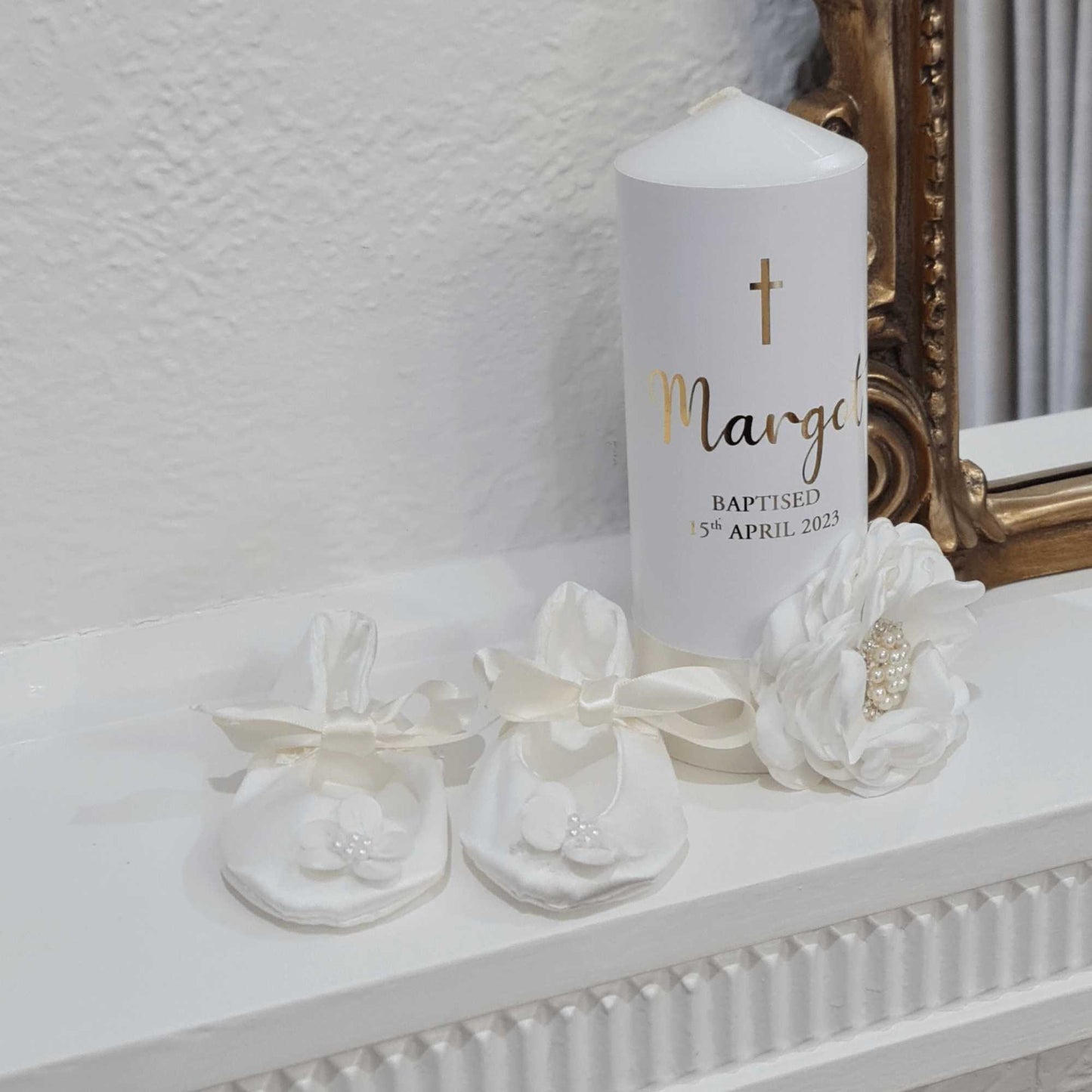 ivory christening candle and handmade shoesfor baptism